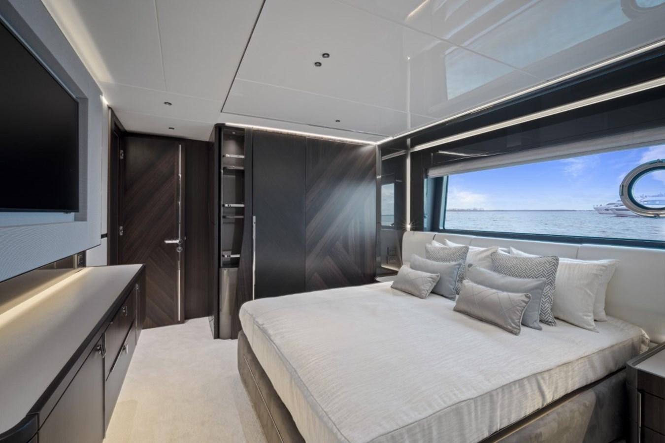 a bed in a room aboard SUNSEEKER 90/25 Yacht for Sale