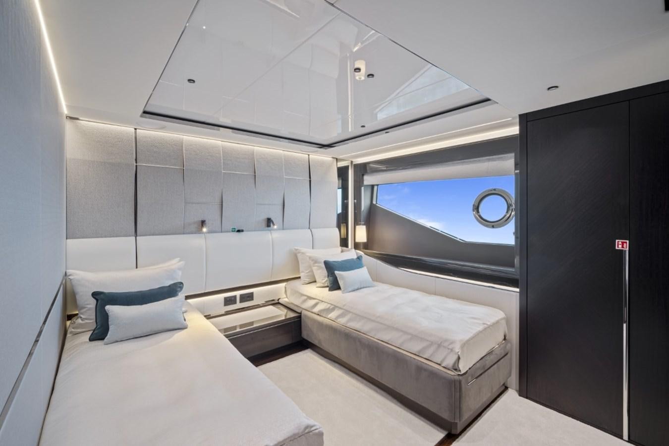 a room with a bed and a window aboard SUNSEEKER 90/25 Yacht for Sale