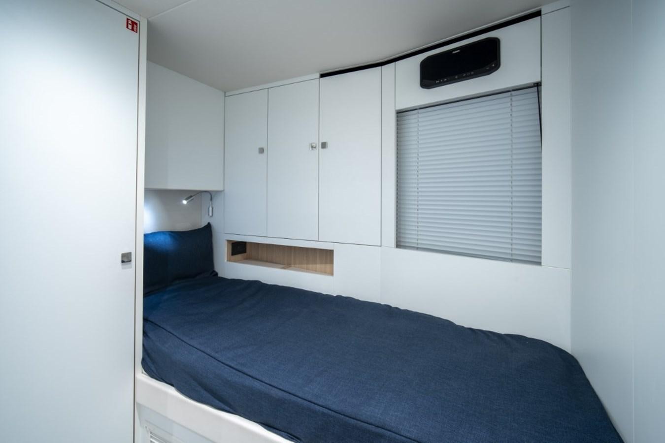 a bed with a blue sheet aboard SUNSEEKER 90/25 Yacht for Sale