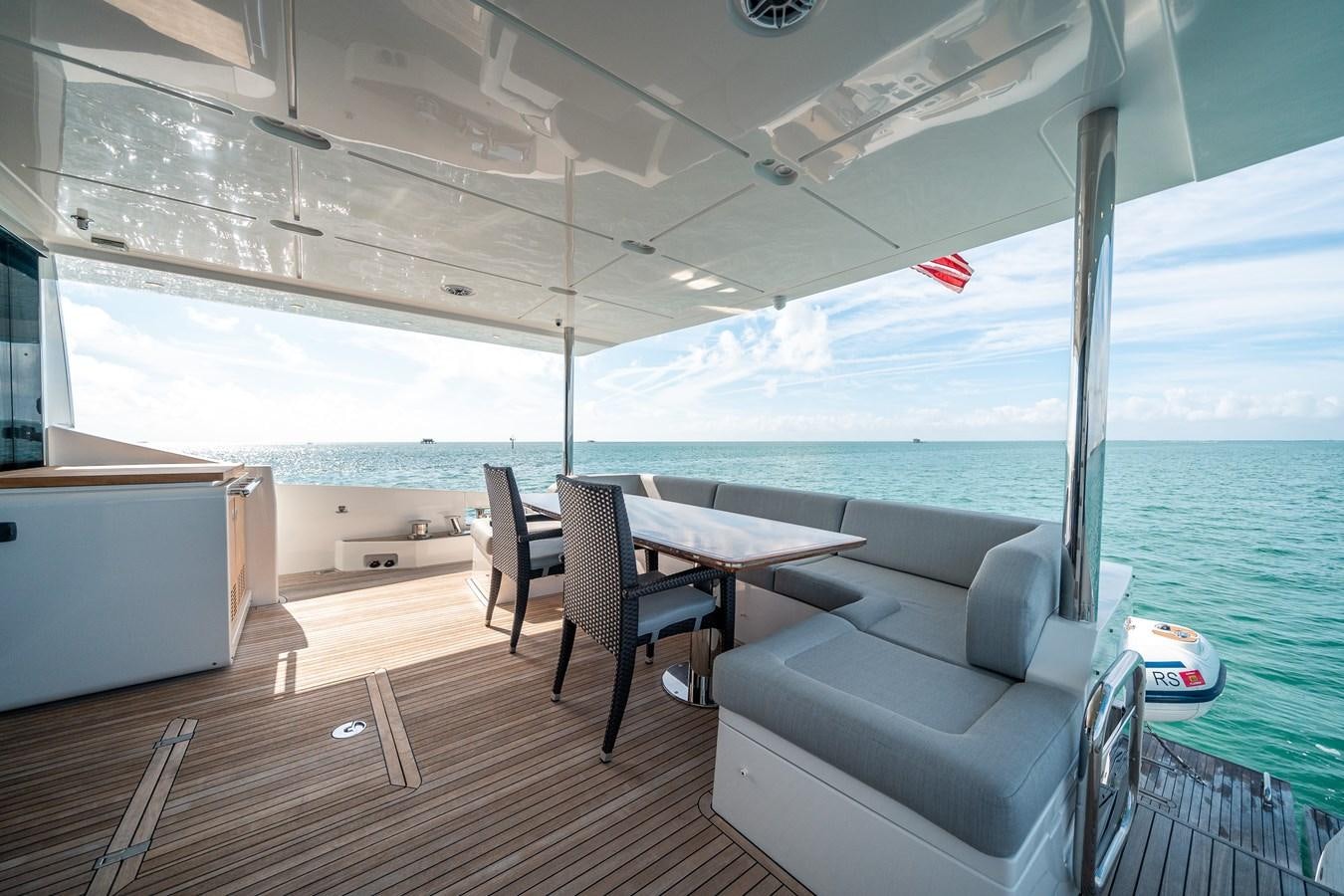 a boat with a table and chairs on a deck aboard 80 AZIMUT Yacht for Sale