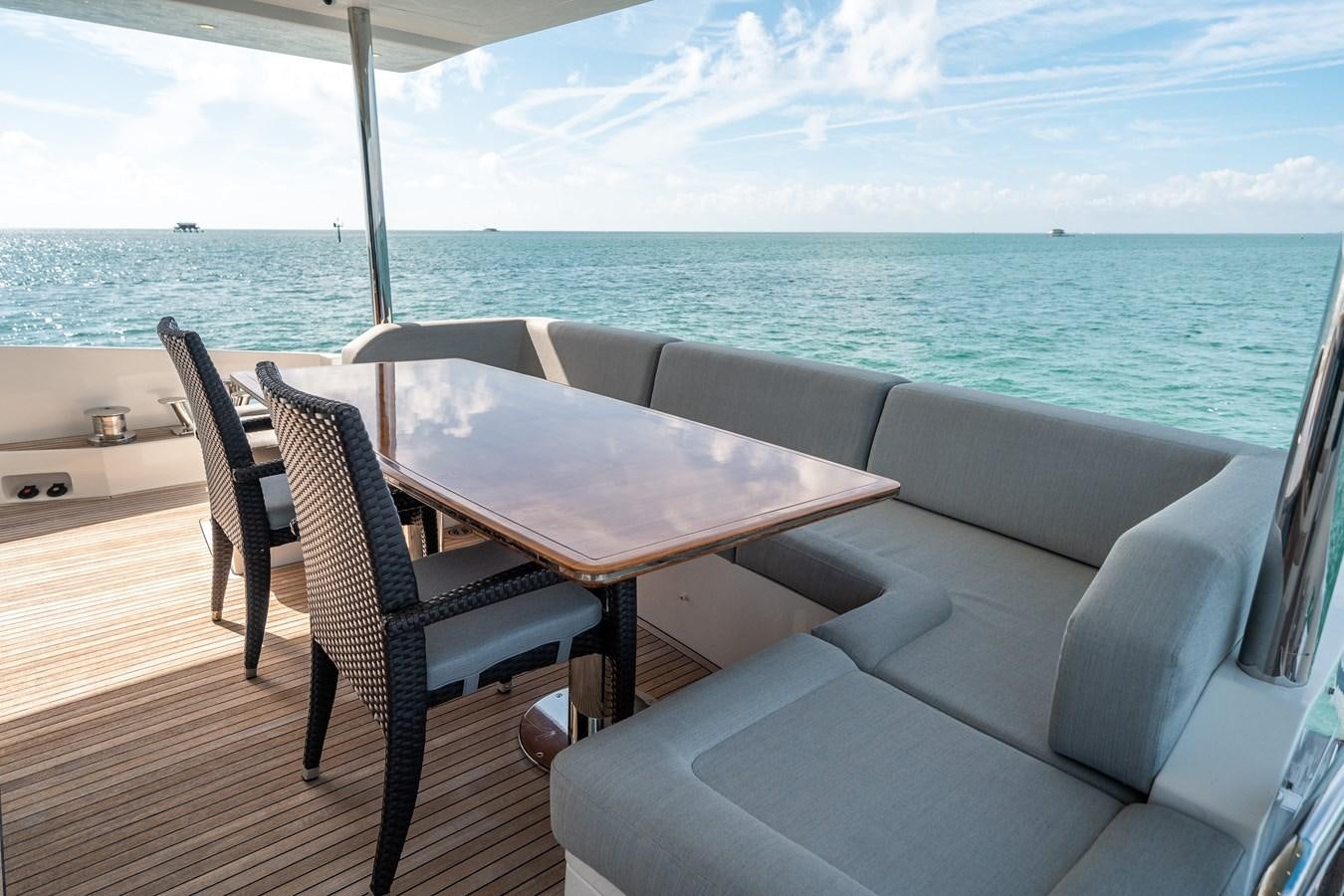 a table and chairs on a deck overlooking the ocean aboard 80 AZIMUT Yacht for Sale