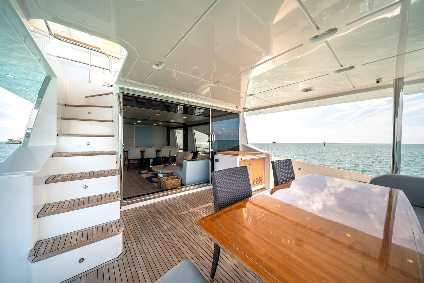 a room with a table and chairs aboard 80 AZIMUT Yacht for Sale
