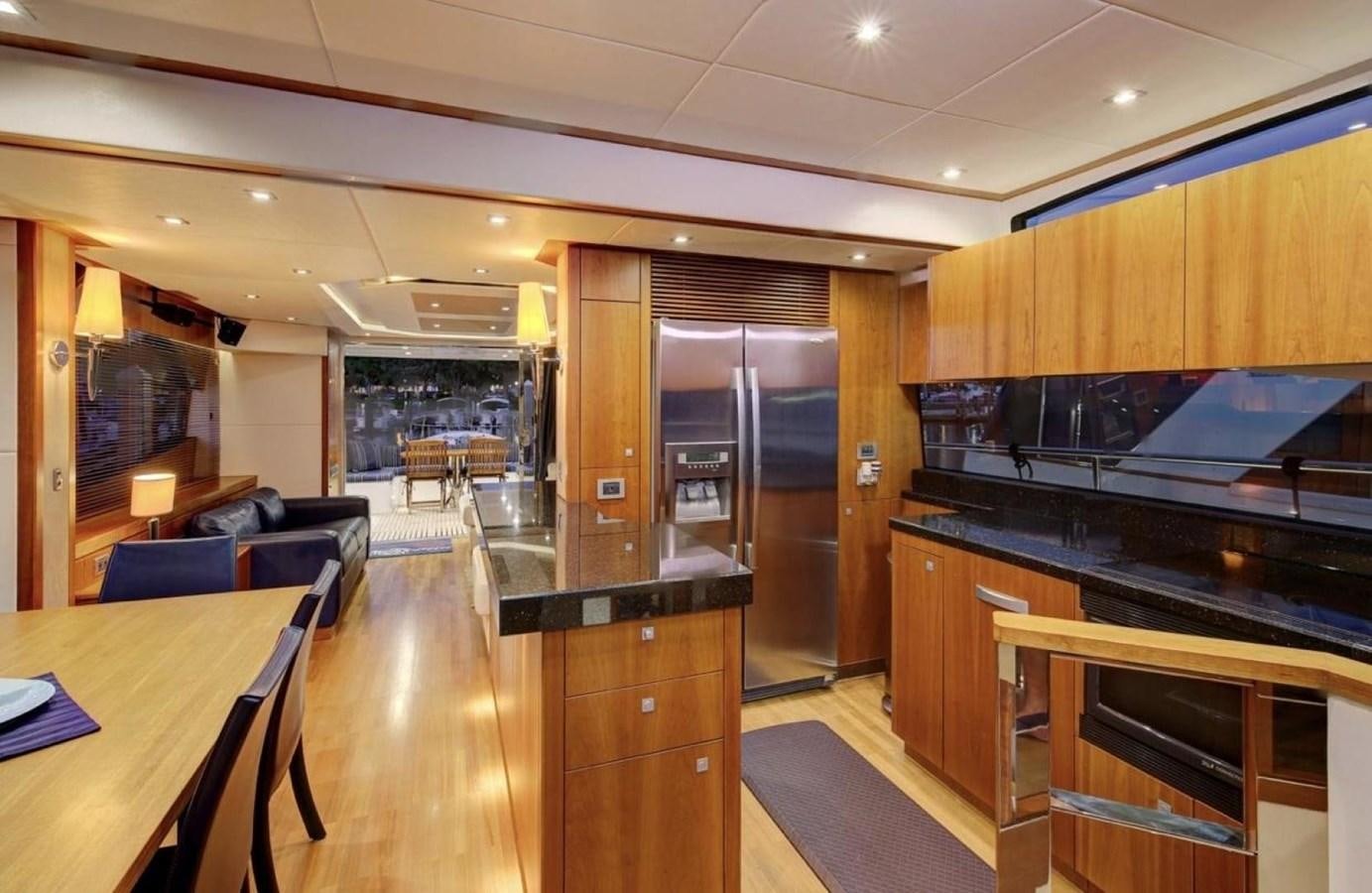 a kitchen with wooden cabinets aboard SUNSEEKER 74 2012 SEA C Yacht for Sale