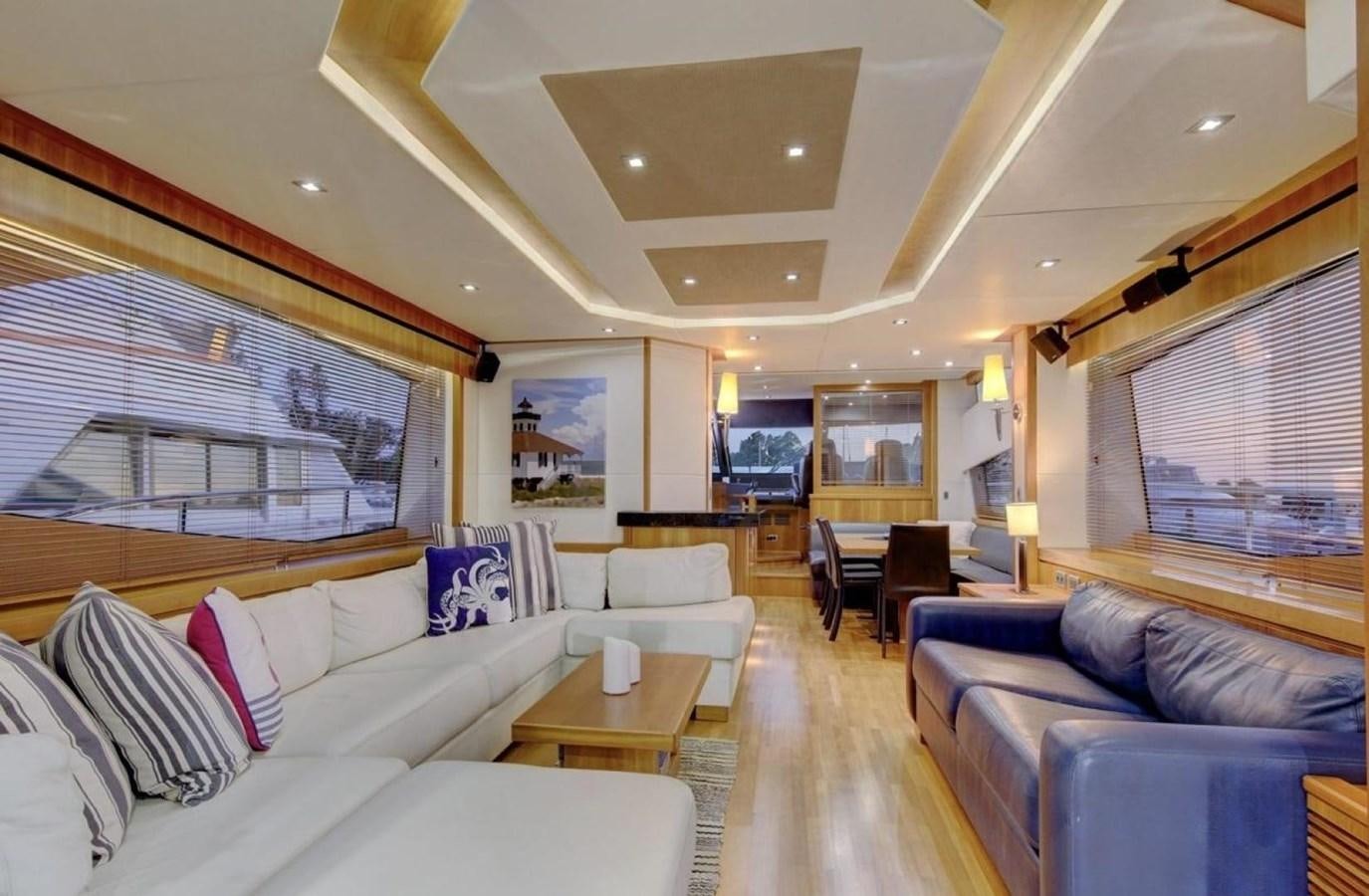 a living room with a large window aboard SUNSEEKER 74 2012 SEA C Yacht for Sale