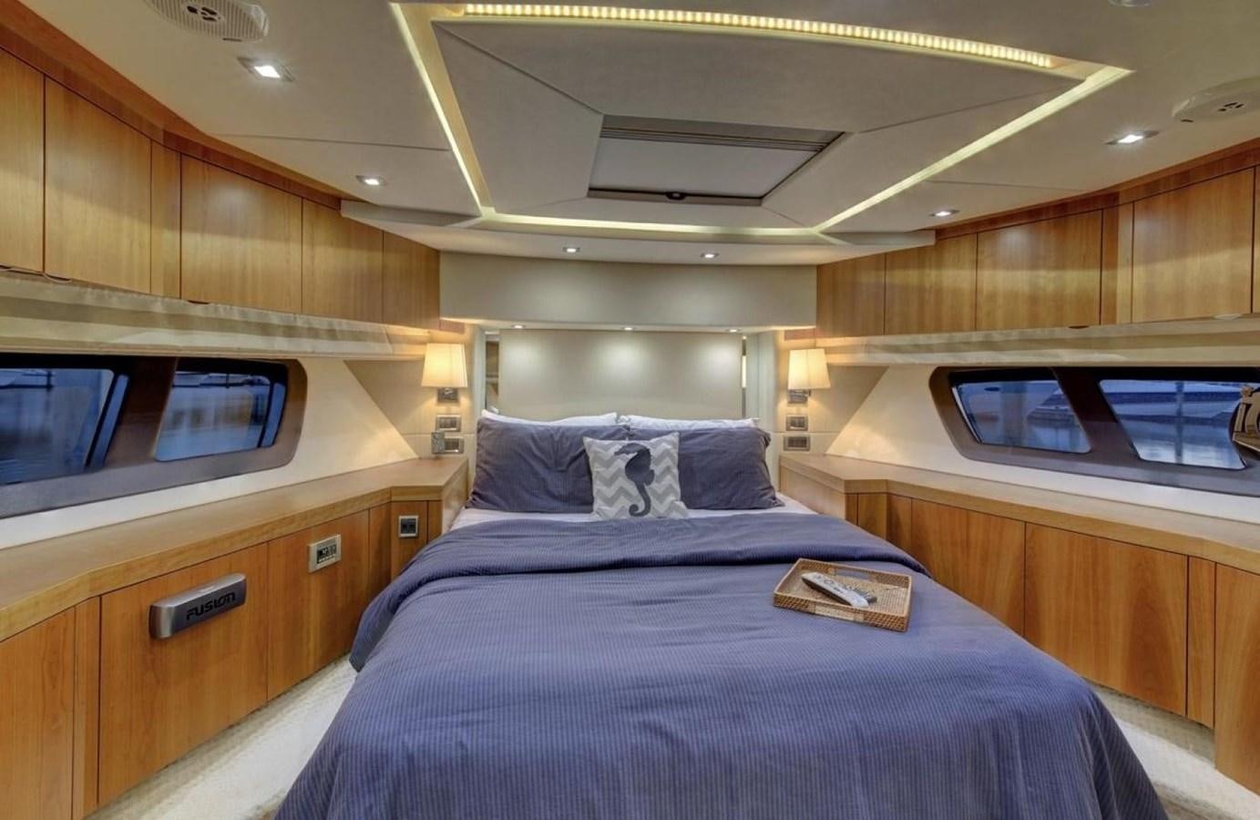 a room with a bed and a television aboard SUNSEEKER 74 2012 SEA C Yacht for Sale