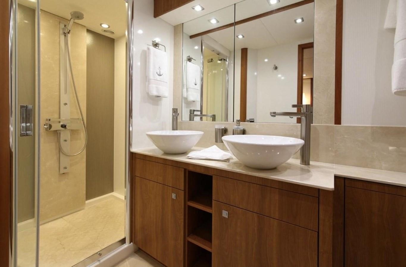 a bathroom with a sink and a shower aboard SUNSEEKER 74 2012 SEA C Yacht for Sale