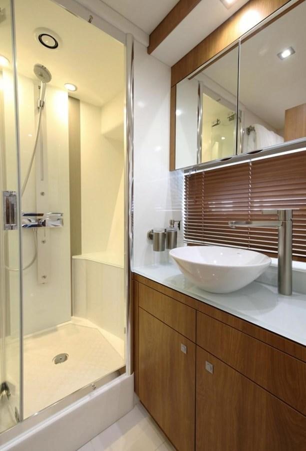 a bathroom with a sink and a shower aboard SUNSEEKER 74 2012 SEA C Yacht for Sale