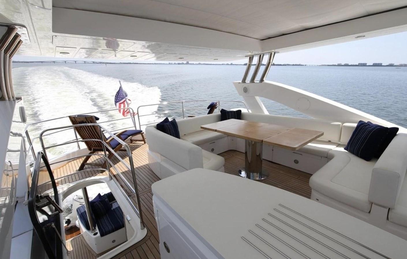 a boat with a table and chairs on it aboard SUNSEEKER 74 2012 SEA C Yacht for Sale
