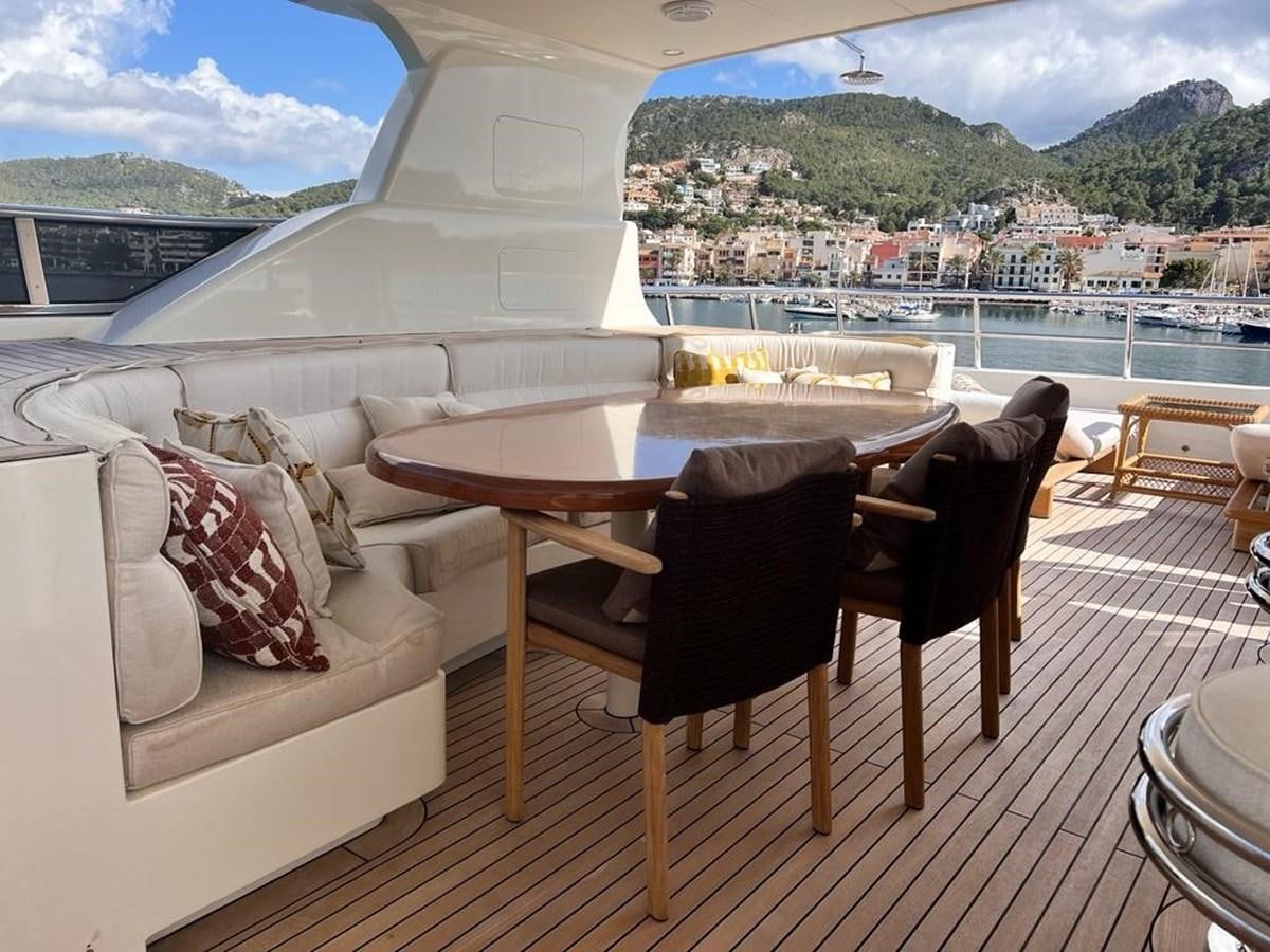 a table and chairs on a balcony aboard O Yacht for Sale