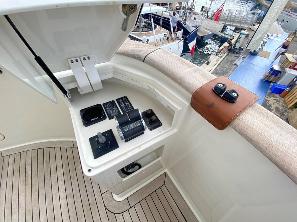 a boat with a wood steering wheel aboard O Yacht for Sale