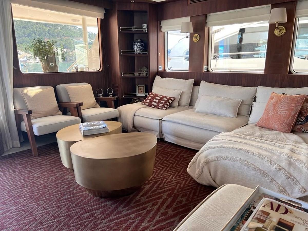 a living room with a couch and a coffee table aboard O Yacht for Sale