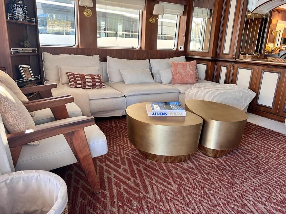 a living room with a couch and a coffee table aboard O Yacht for Sale