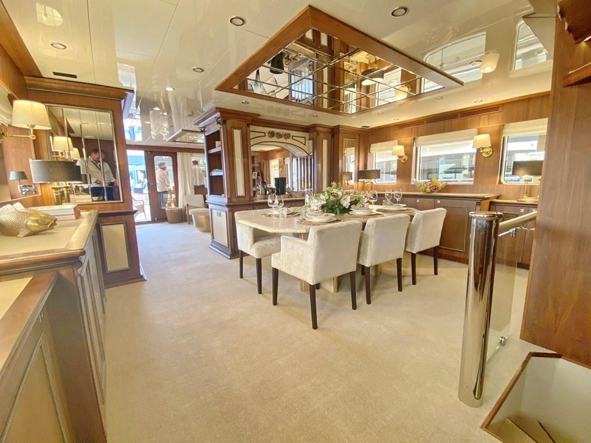 a large kitchen with a table aboard O Yacht for Sale