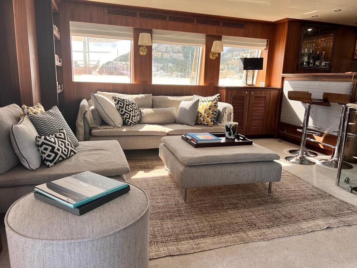 a living room with a couch and a coffee table aboard O Yacht for Sale