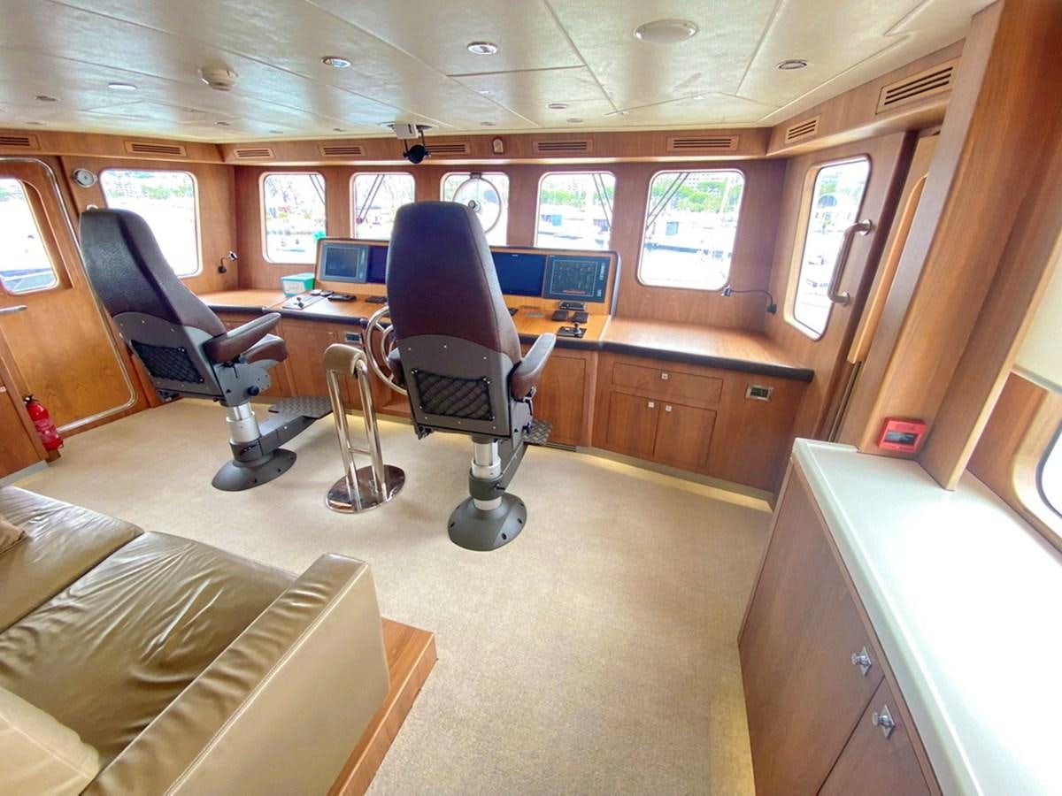 a room with a desk and chairs aboard O Yacht for Sale