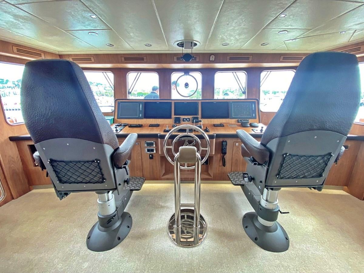 a couple of chairs in a room aboard O Yacht for Sale