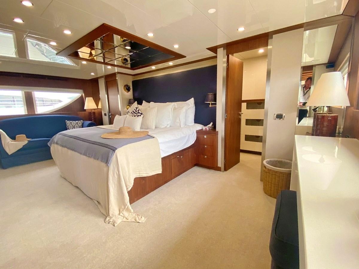 a bedroom with a bed and a desk aboard O Yacht for Sale