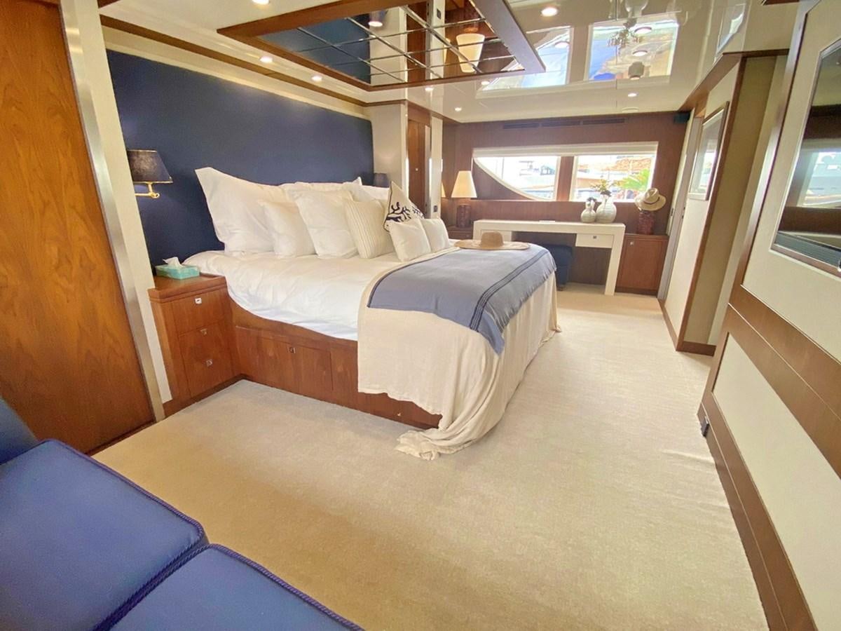 a room with a bed and a desk aboard O Yacht for Sale