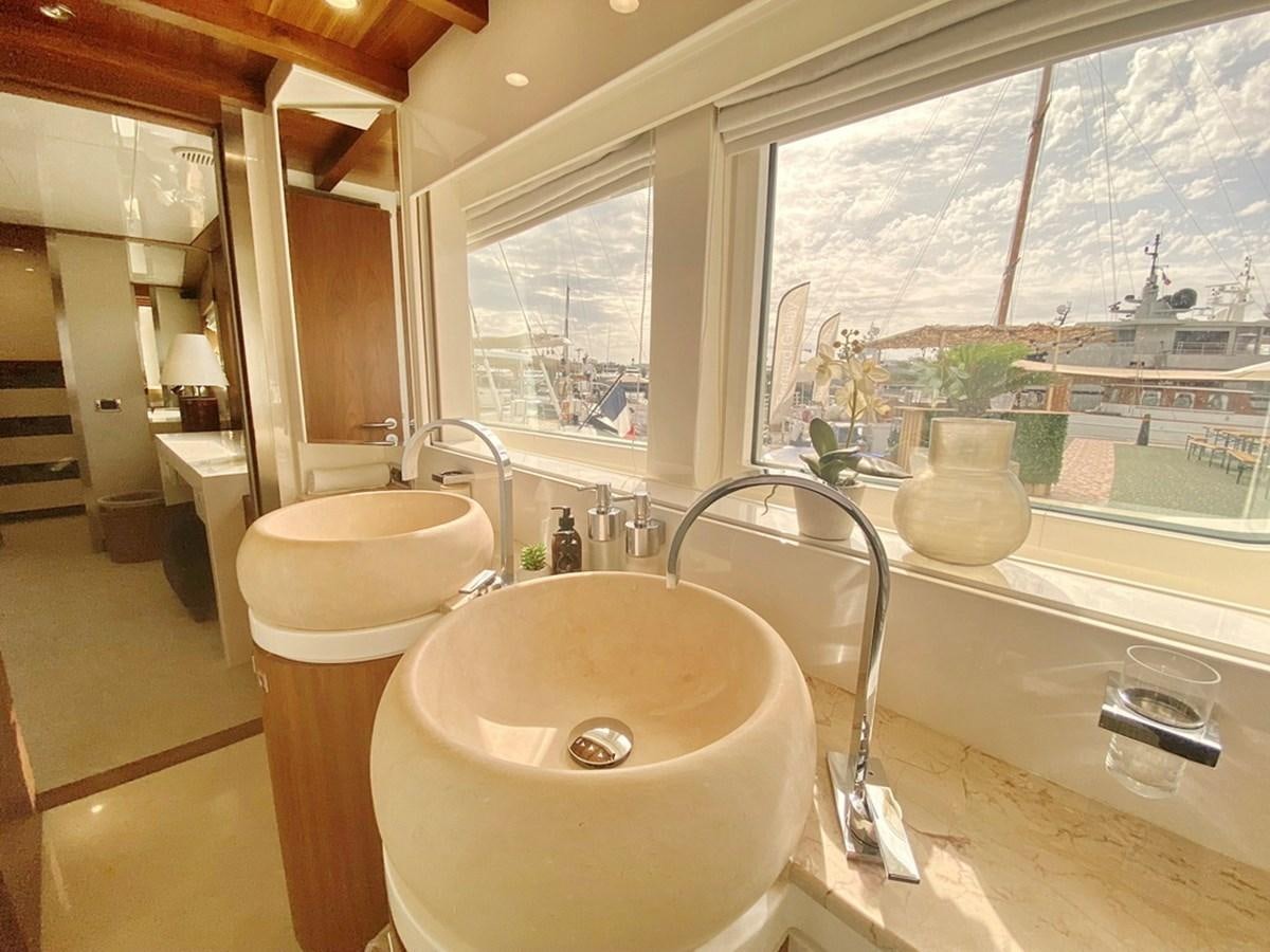 a bathroom with a sink and a window aboard O Yacht for Sale