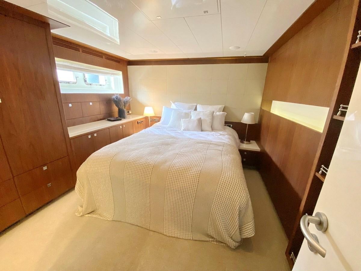 a bedroom with a bed and a closet aboard O Yacht for Sale