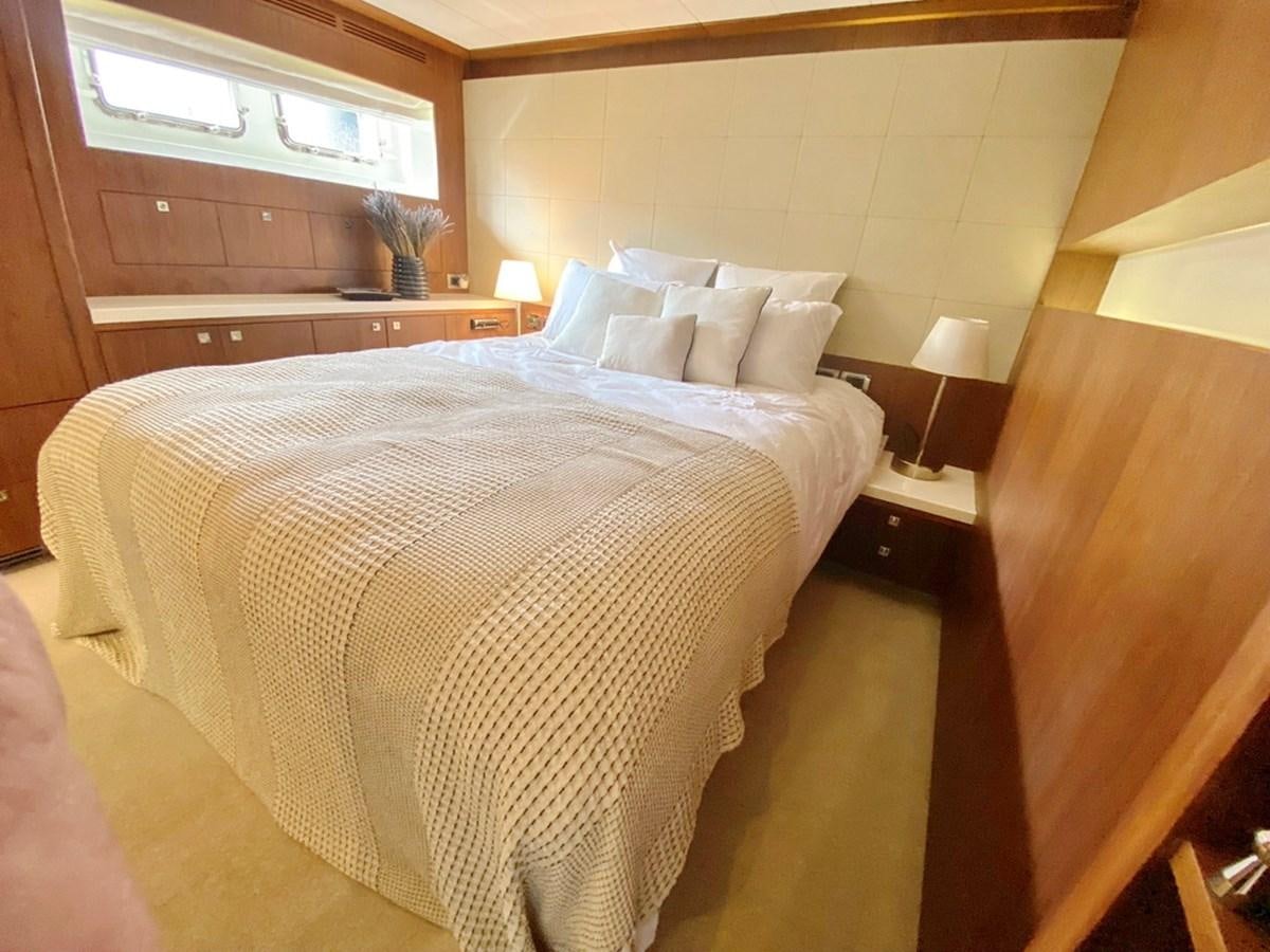 a bed with white sheets aboard O Yacht for Sale