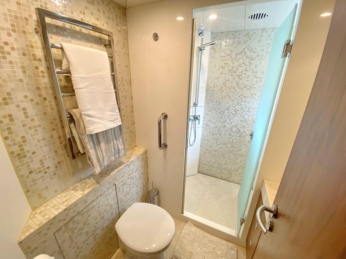 a bathroom with a glass shower door aboard O Yacht for Sale