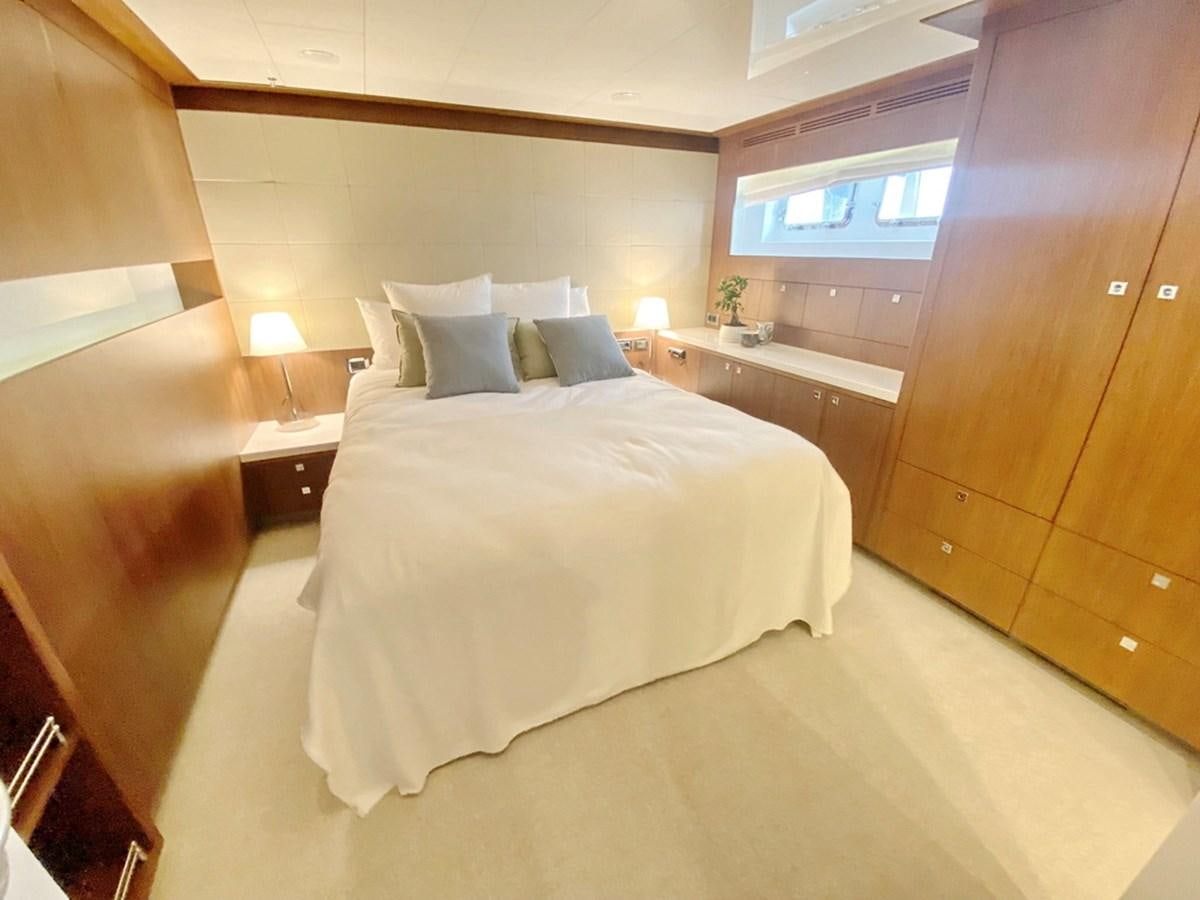 a bedroom with a bed and a desk aboard O Yacht for Sale