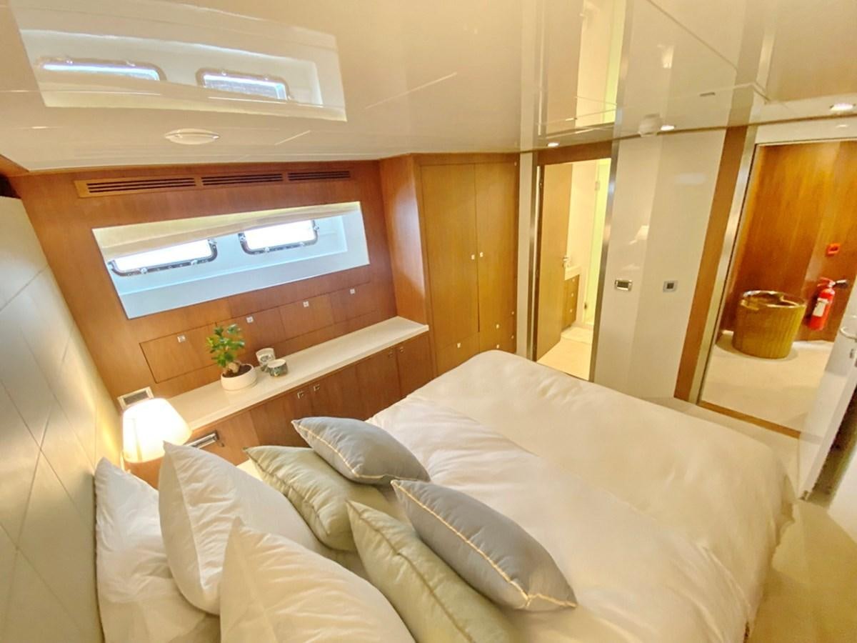 a bed with white sheets aboard O Yacht for Sale