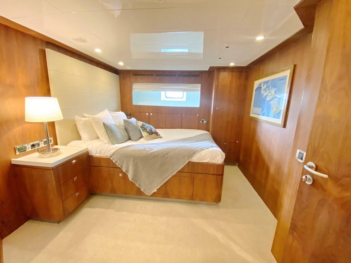 a room with a bed and a desk aboard O Yacht for Sale