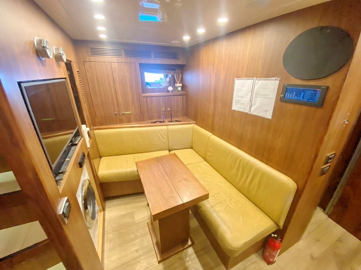 a room with a couch and a table aboard O Yacht for Sale