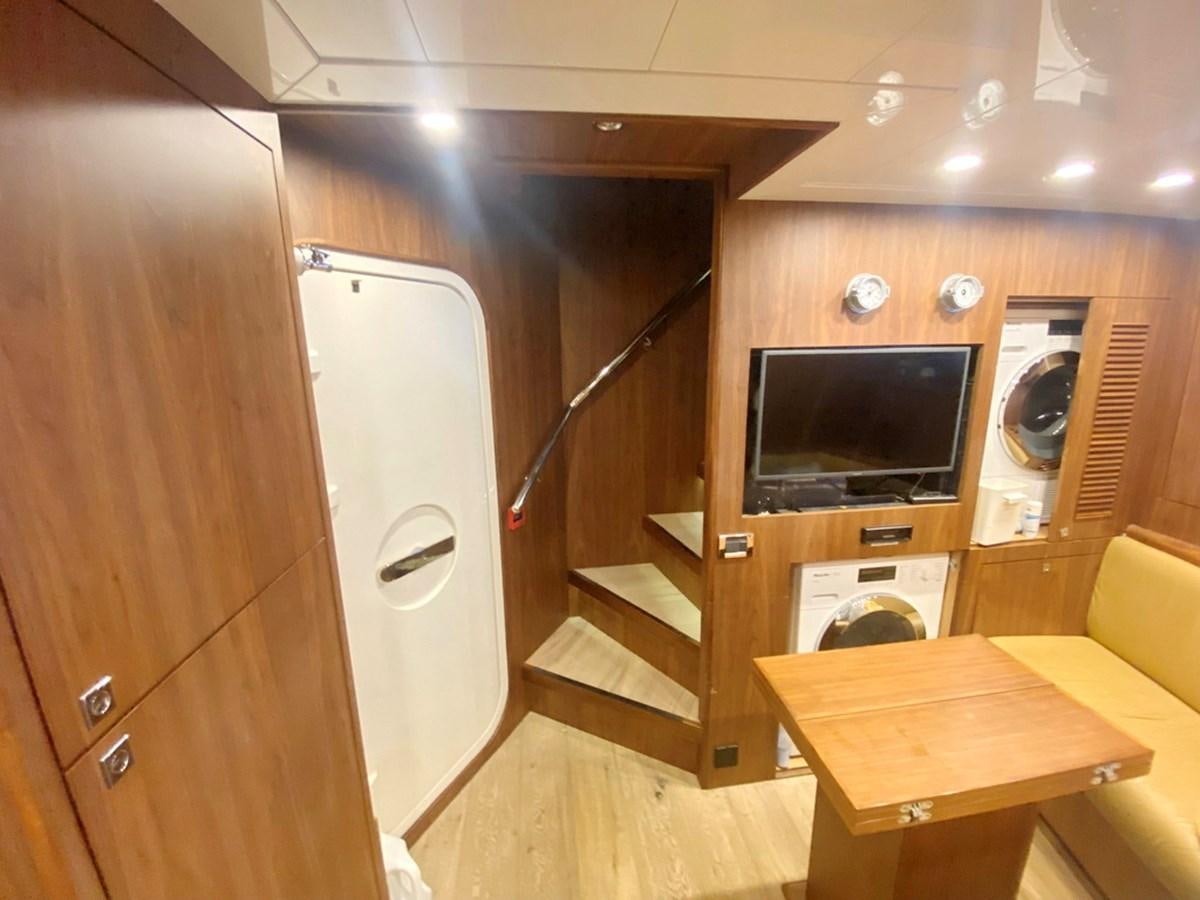 a room with a tv and a bed aboard O Yacht for Sale