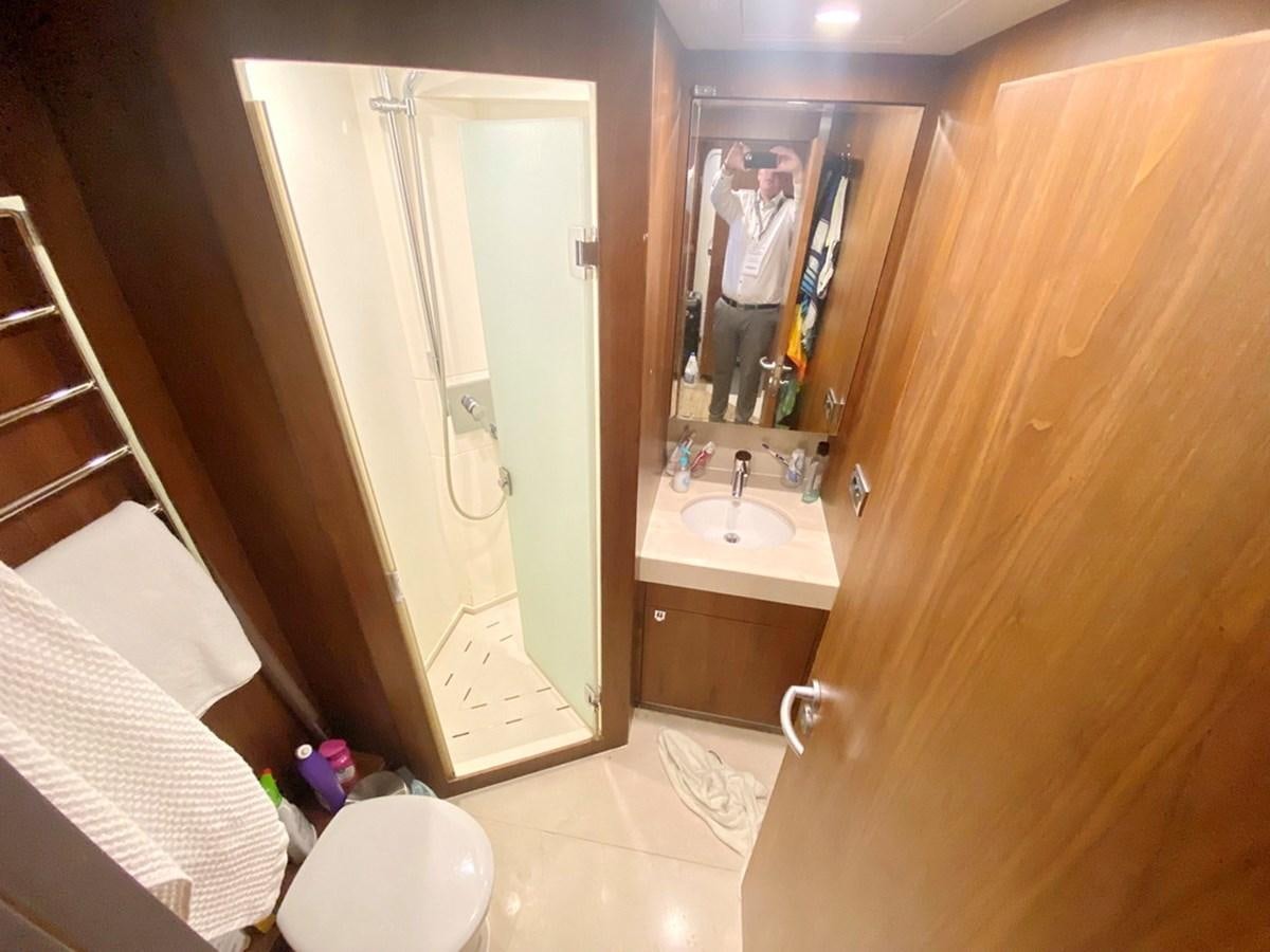 a bathroom with a mirror and a sink aboard O Yacht for Sale