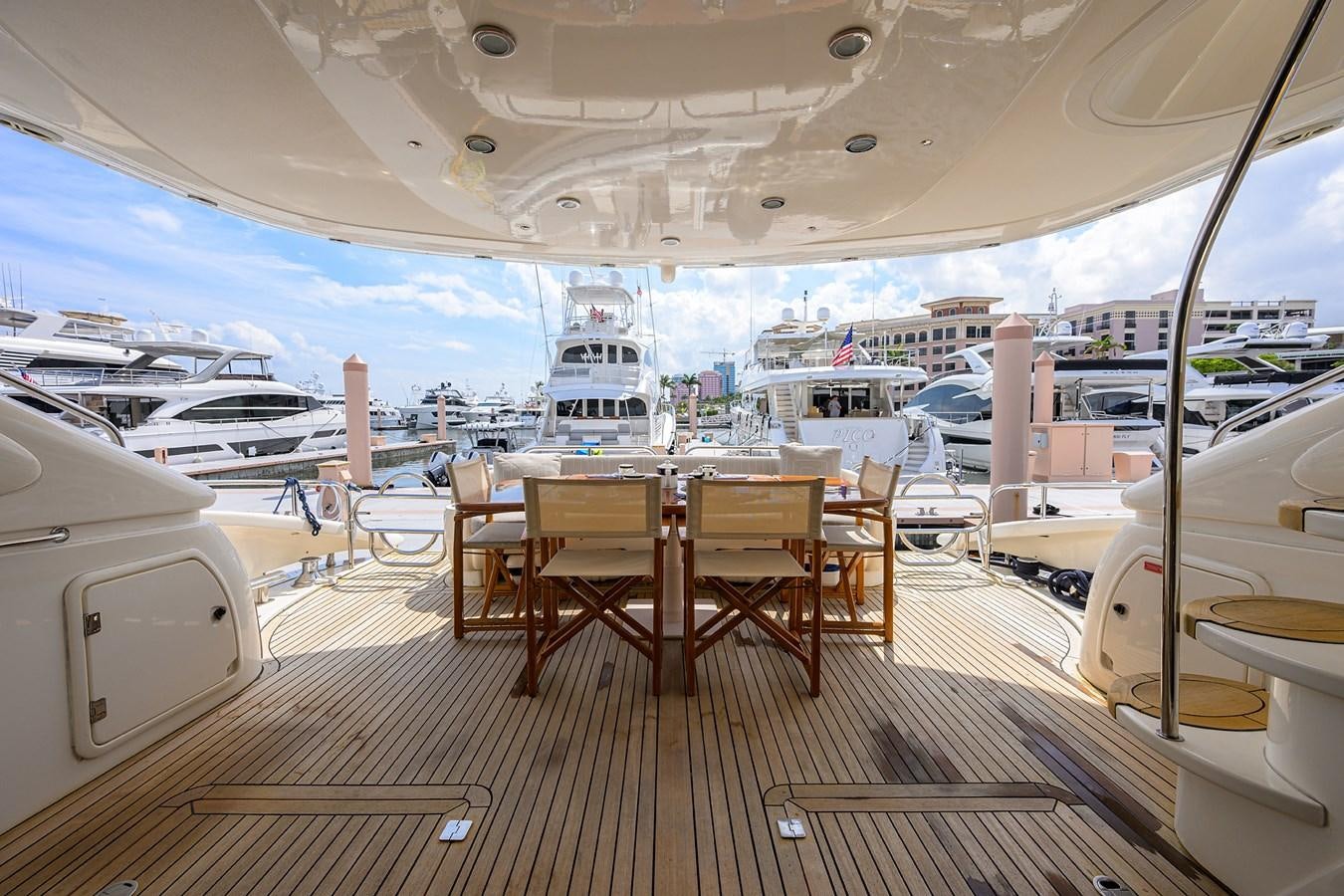 a boat dock with tables and chairs aboard MISTRAL Yacht for Sale