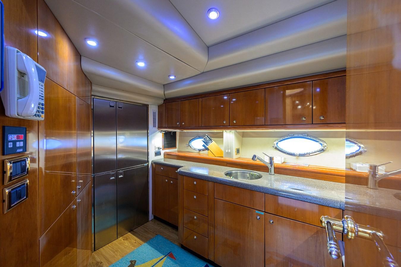 a kitchen with wooden cabinets aboard MISTRAL Yacht for Sale