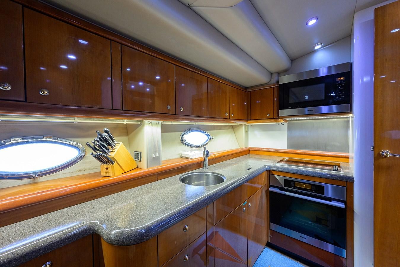 a kitchen with wooden cabinets aboard MISTRAL Yacht for Sale