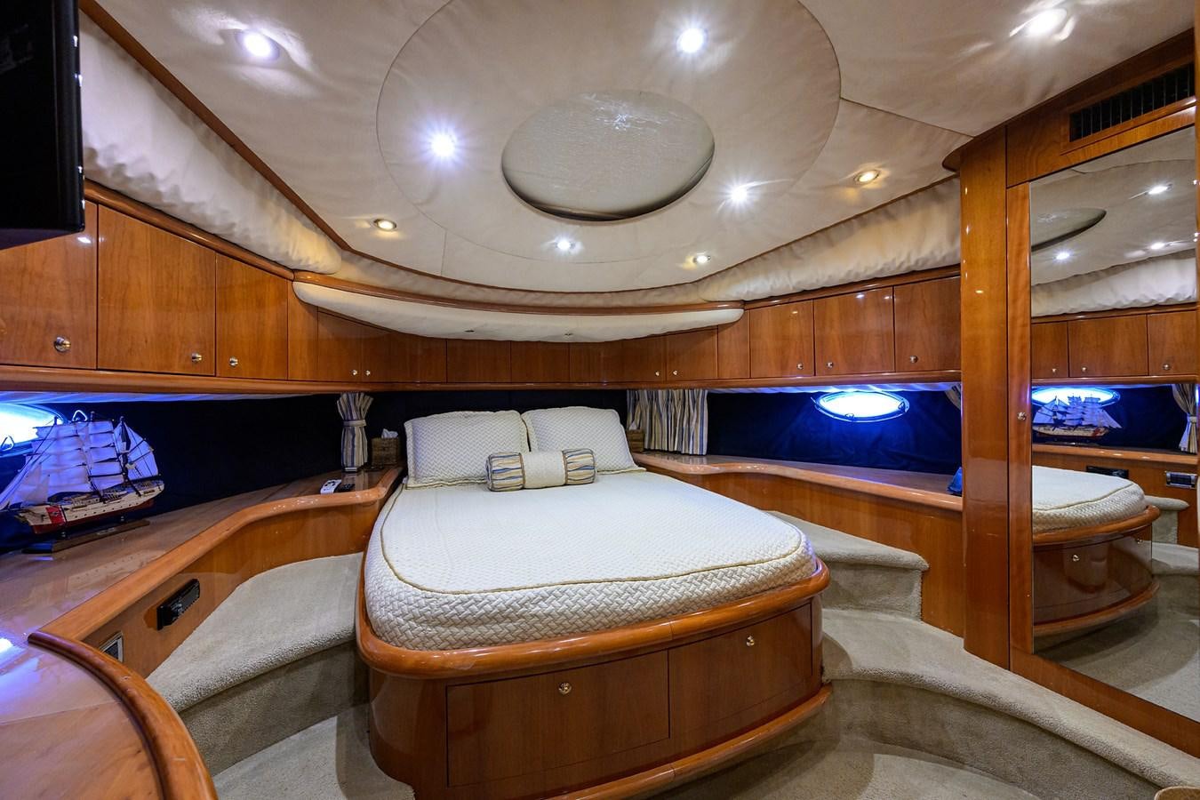 a room with a bed and a mirror aboard MISTRAL Yacht for Sale