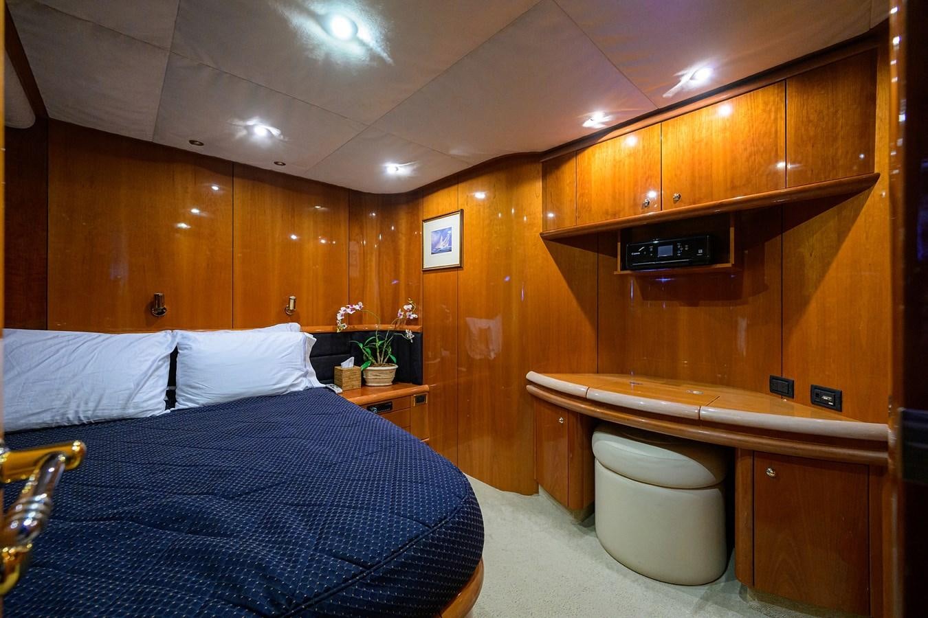 a bedroom with a bed and a desk aboard MISTRAL Yacht for Sale