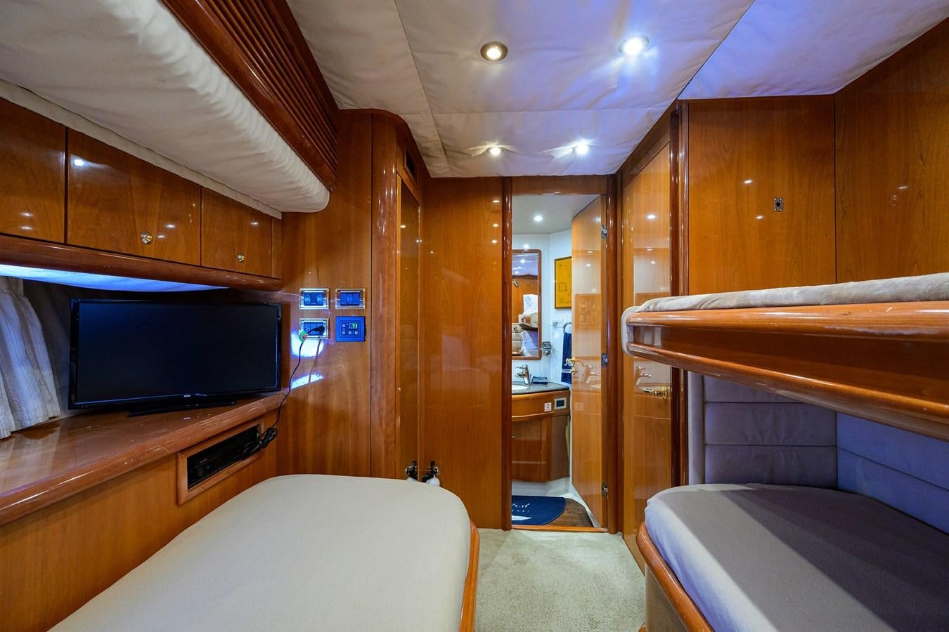 a room with a bed and a television aboard MISTRAL Yacht for Sale