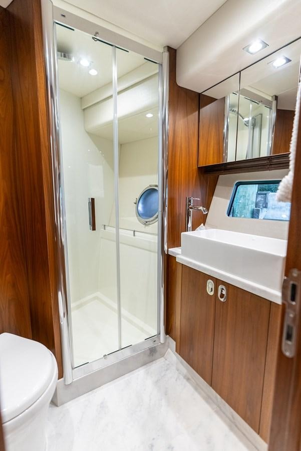 a bathroom with a shower unit and a sink aboard SHANTI Yacht for Sale