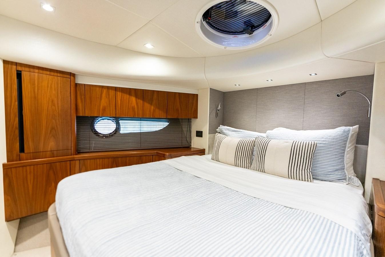 a room with a bed and a wood cabinet aboard SHANTI Yacht for Sale