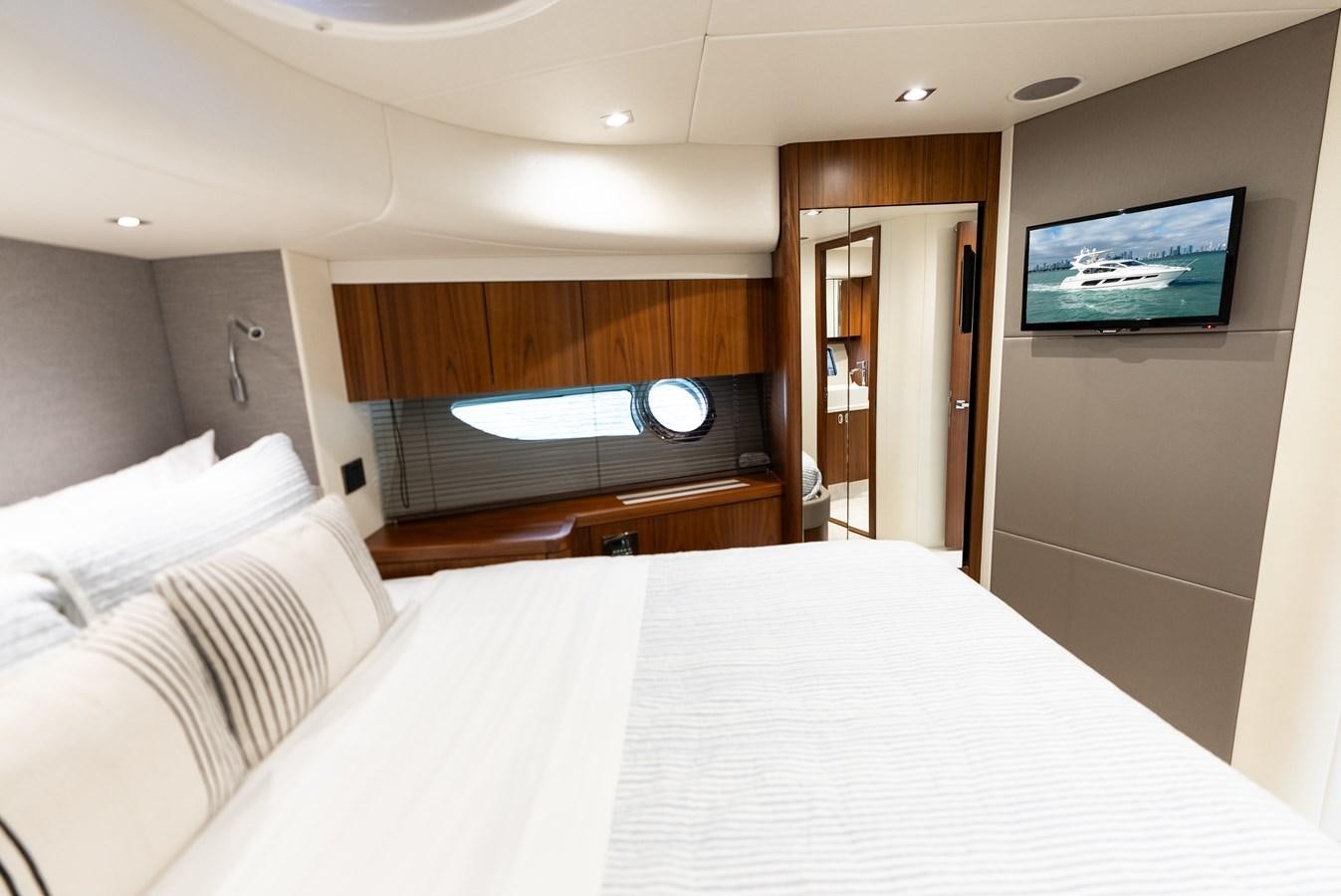a hotel room with a bed and a television aboard SHANTI Yacht for Sale