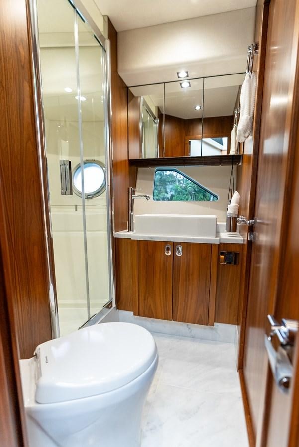 a bathroom with a glass shower aboard SHANTI Yacht for Sale