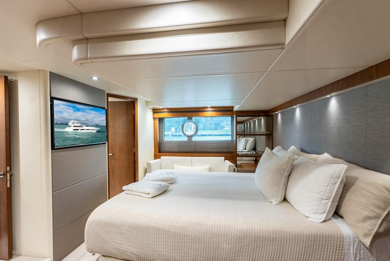 a bed with pillows and a television aboard SHANTI Yacht for Sale
