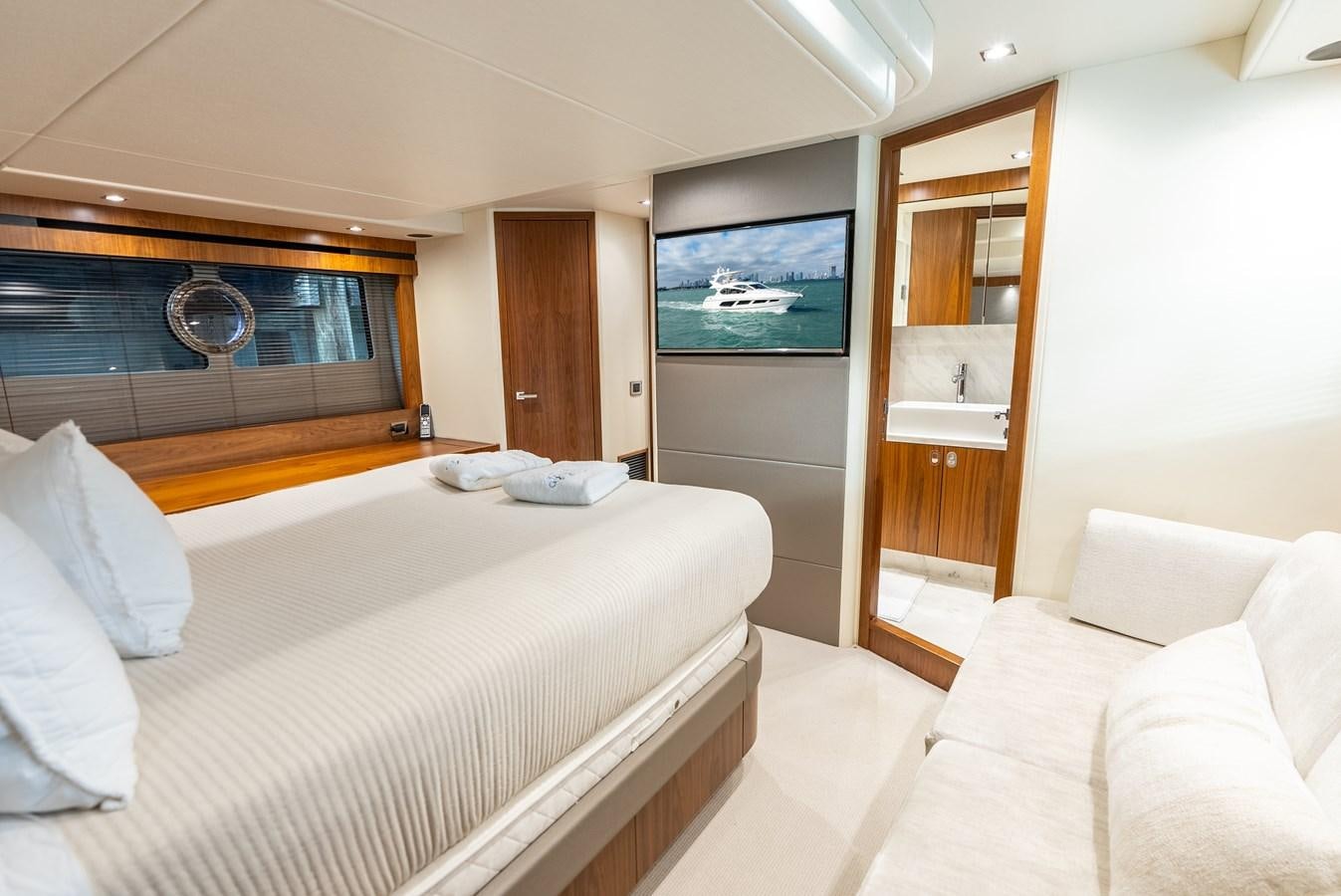 a hotel room with a bed and a tv aboard SHANTI Yacht for Sale