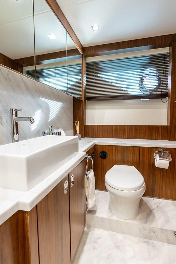 a bathroom with a toilet and a sink aboard SHANTI Yacht for Sale