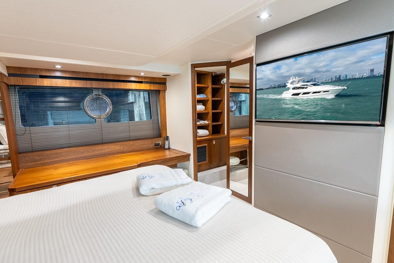 a bedroom with a large tv aboard SHANTI Yacht for Sale