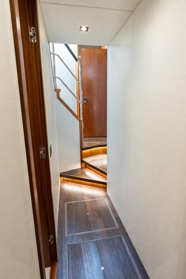 a hallway with a door and a glass door aboard SHANTI Yacht for Sale