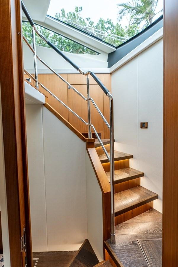 a staircase with a glass window aboard SHANTI Yacht for Sale