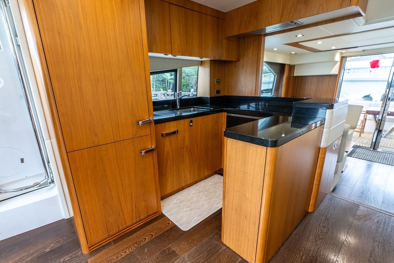 a kitchen with wooden cabinets aboard SHANTI Yacht for Sale