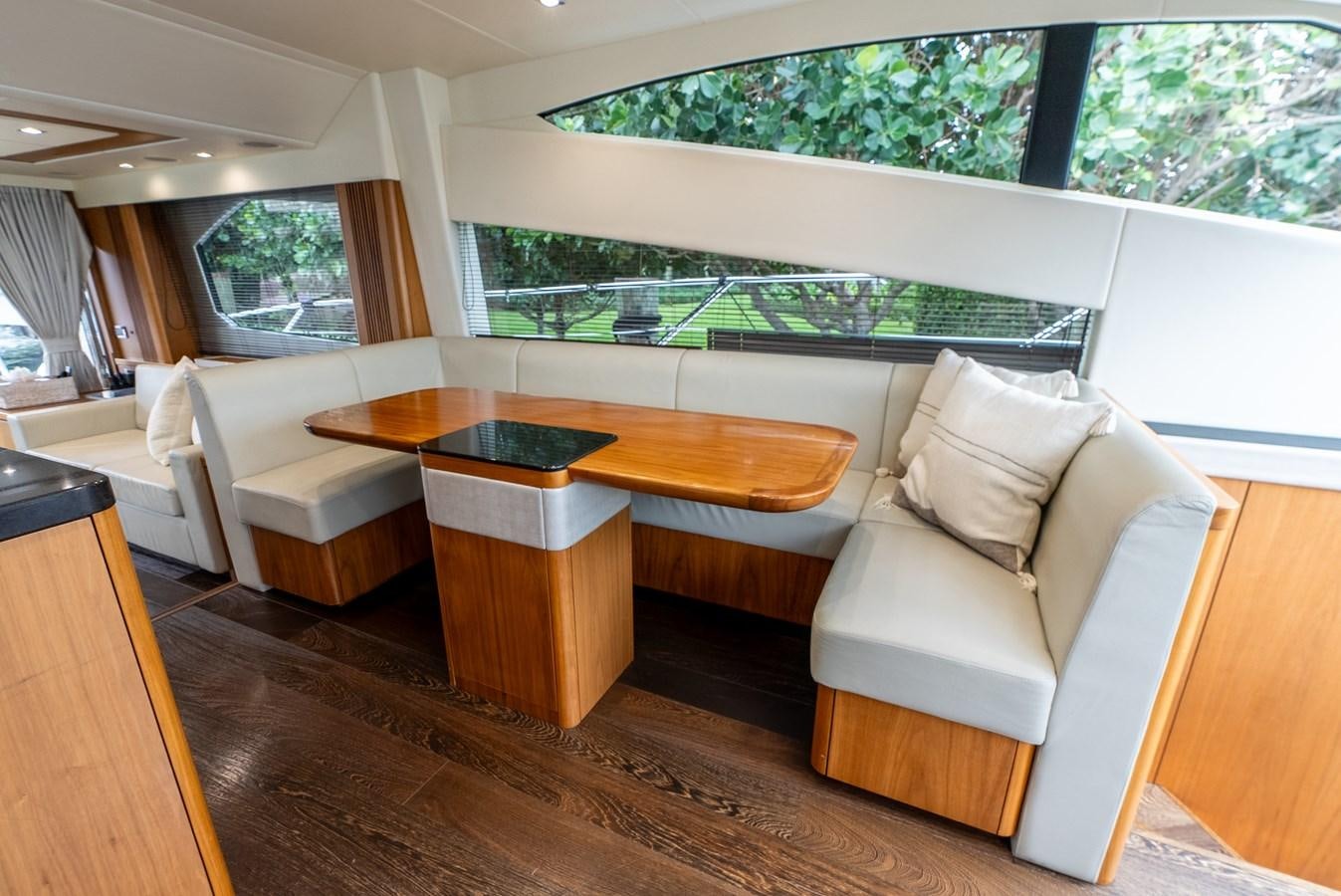 a living room with a table and chairs aboard SHANTI Yacht for Sale